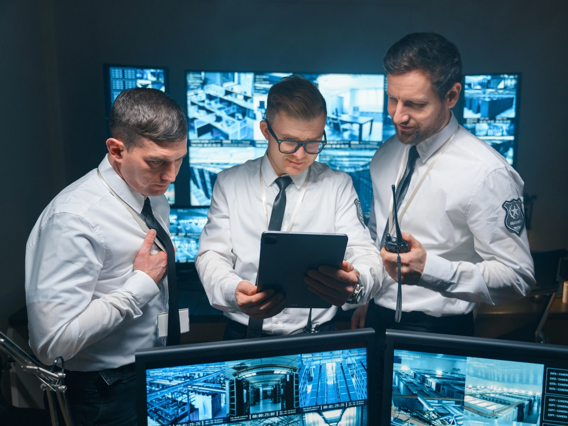 Men analyzing security data on screens
